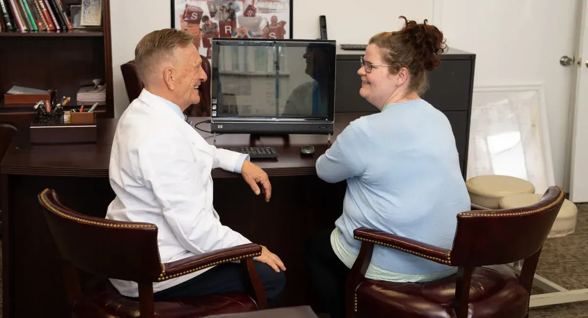 Dr. Toth at his desk going over a care plan with a patient
