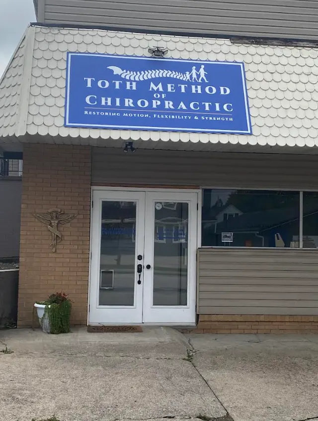 Front entrance of Toth Chiropractic and Wellness at 3461 University Ave in Morgantown, WV, under the blue Toth Method of Chiropractic sign