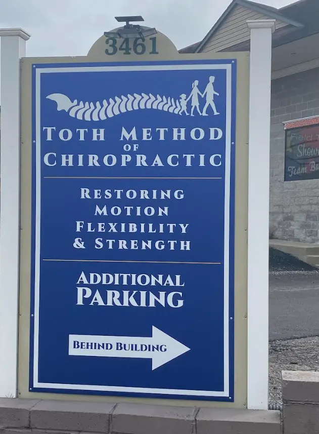 Toth Method of Chiropractic sign at 3461 University Ave, Morgantown, with an arrow pointing to additional parking behind the building